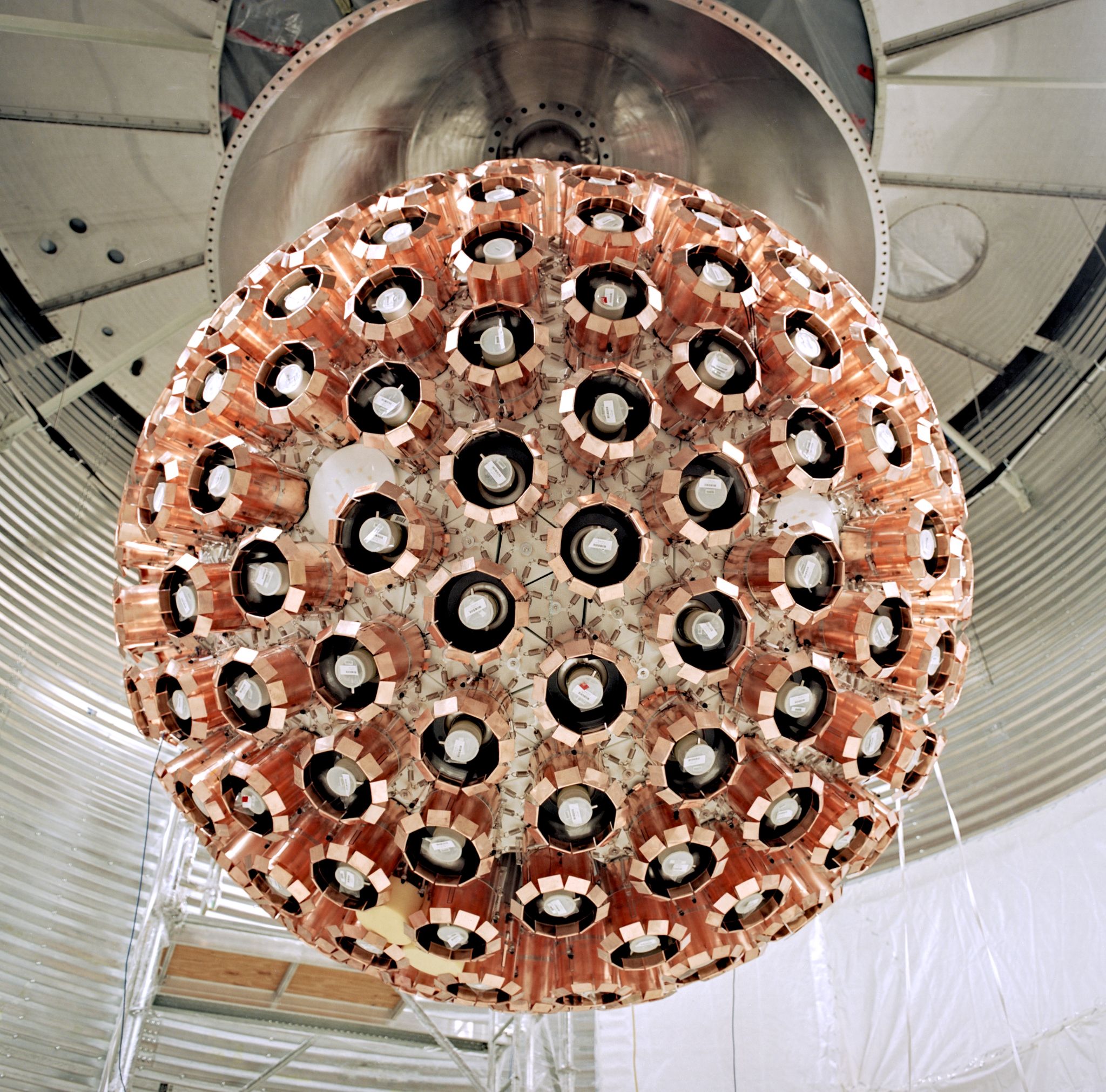 The acrylic vessel suspended inside the water tank, with PMTs at the ends of the 50cm-long acrylic lgiht guides and copper collars around the PMTs