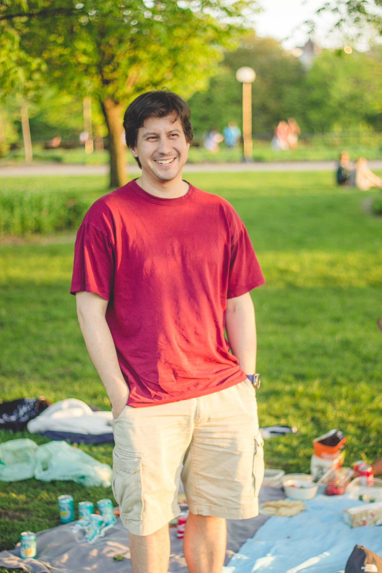 Photograph of Shawn Westerdale, smiling and wearing a red shirt in a park